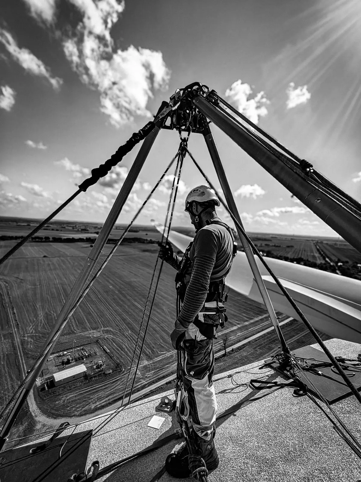 Technician at a lifting gantry on the roof of a structure
